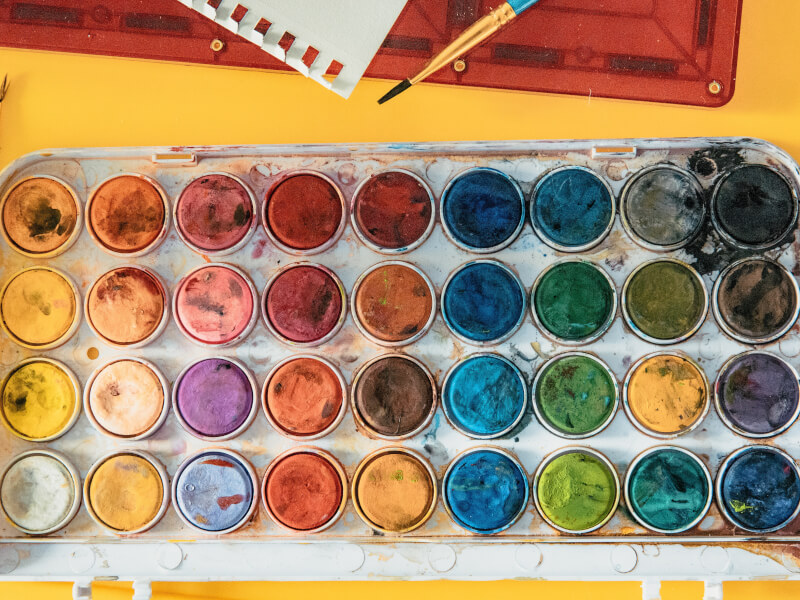 a box of watercolour paint pots in a variety of different colours